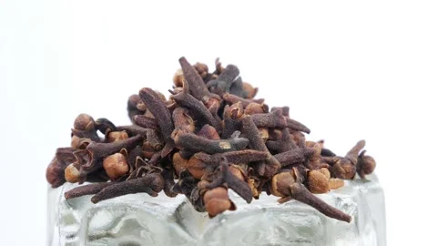 Rotating shot of cloves placed over glass 動画素材 147691061