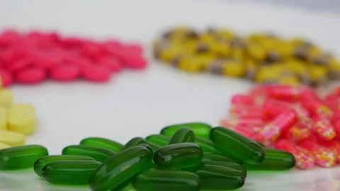 Rotating shot of colorful tablets placed over a white table Video stock 147700204