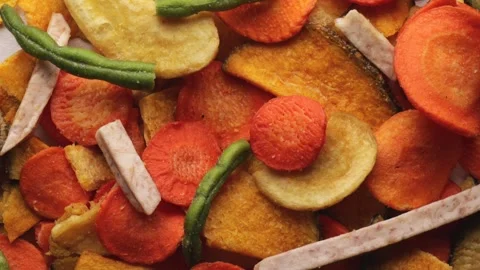 Rotating shot of dried vegetable chips including carrot, potato, green bean.. Stock Footage 318674842