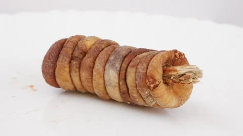 Rotating shot fig dry fruit isolated over white background Stockbeeldmateriaal 148212673