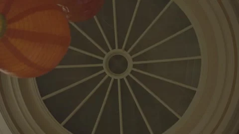 Rotating shot at glass ceiling in old building with red lanterns coming in frame 스톡 동영상 294696944
