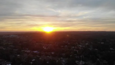 Rotating shot of a golf coarse moving up to reveal a beautiful sunset Stock Footage 136023929