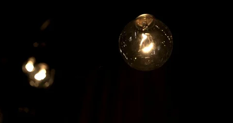 Rotating shot of a single lightbulb Stock Footage 98366223