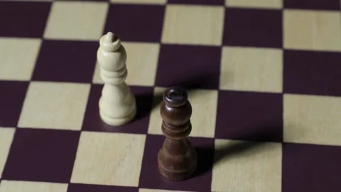 Rotating shot of two chess queens with shadows on chessboard. Stock Footage 314378190