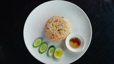 Rotating shot. View from above of a dish of rice and pieces of vegetables Stock Footage 220241849