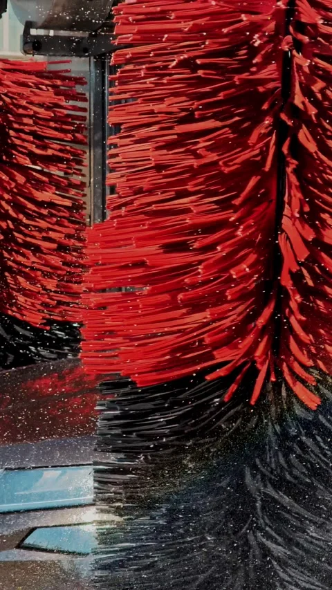Rotating side brush cleaning body of black vehicle close up Video stock 343794040