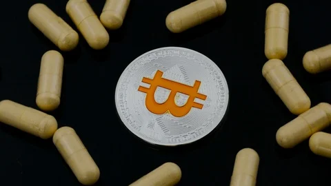 Rotating silver bitcoin with many troches on the black background Stock Footage 88224905