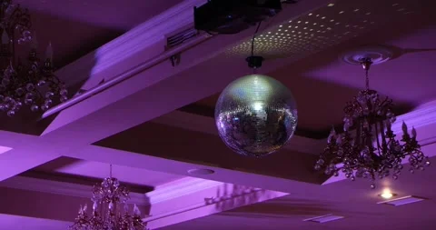 Rotating silver mirror disco ball with bright rays at a party or celebration Stock Footage 222131092
