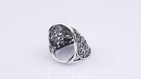 Rotating silver ring with reflection on light gray background. Video rotation Stock Footage 291171342
