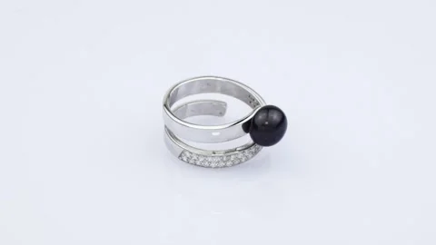 Rotating silver ring with reflection on light gray background. Video rotation Stock Footage 291171422