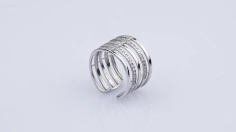 Rotating silver ring with reflection on white background. Video rotation 360 Stock Footage 291171341