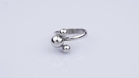 Rotating silver ring with reflection on white background. Video rotation 360 Stock Footage 291171354