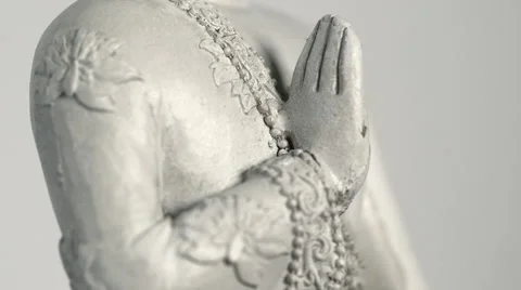 Rotating sitting Buddha statue, medium tilt up against white background Stock Footage 65479370