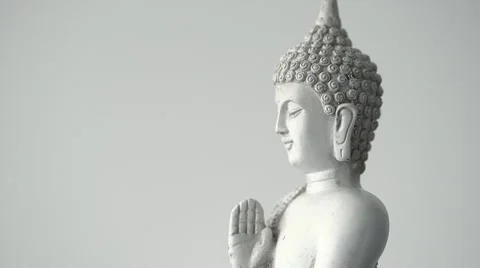 Rotating sitting Buddha statue medium macro shot against white background (loop) Stock Footage 65479411