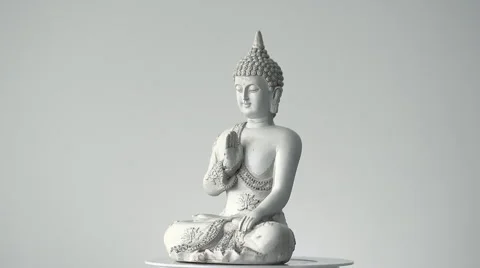 Rotating sitting Buddha statue total shot against white background (loop) Stock Footage 65479410