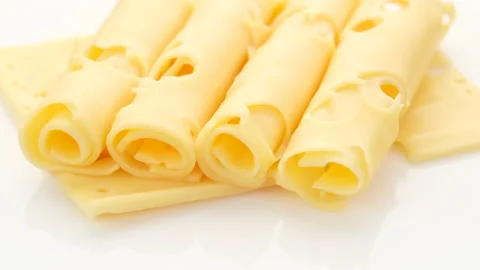 Rotating sliced cheese with holes. macro Stock Footage 133435149