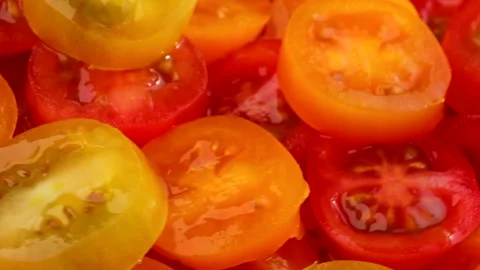 Rotating slices of cherry tomatoes glowing with freshness, tomato texture r.. Stock Footage 319825011