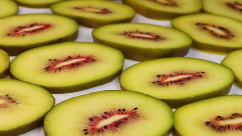 Rotating slices of red kiwi fruit arranged in pattern showcasing vibrant co.. Stock Footage 319825258