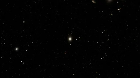 The rotating space section, at center the far and poorly shining galaxy Stock Footage 47379323