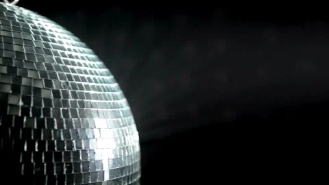 Rotating sparkling disco ball with lights hanging from ceiling. Concept of .. Stock Footage 265761791