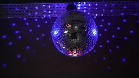 Rotating sparkling mirrored disco ball with light reflections on night party Stock Footage 236454949