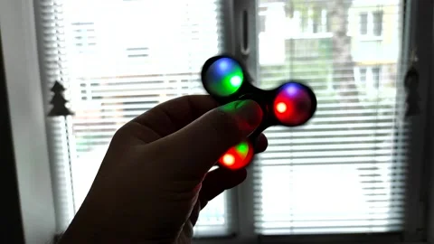 Rotating spinner with LED light in a hand of man. Stock Footage 154720904