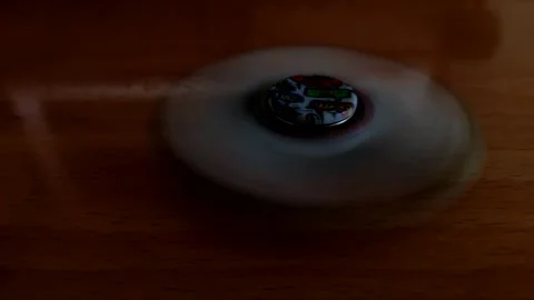Rotating spinner on a old wooden table. Stock Footage 154065677
