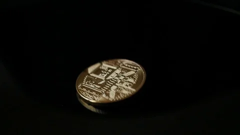 Rotating, spinning cryptocurrency coin, bitcoin on black, slow motion 動画素材 88424716