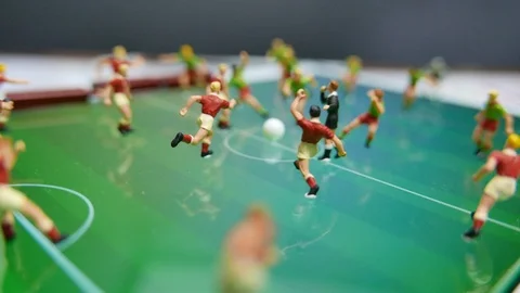 Rotating (spinning) side view of miniature toys figurines football players Stock Footage 108049820