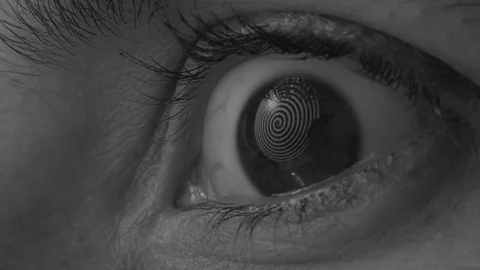 Rotating spiral reflected in a woman's eye Stock Footage 117414307