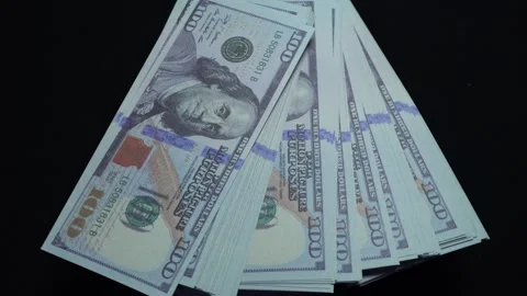 A rotating stack of 100 American dollar bills Video stock 282235374