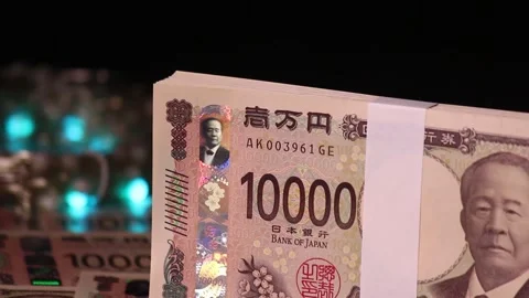 A rotating stack of 10,000 yen bills and illumination Stock Footage 307076301