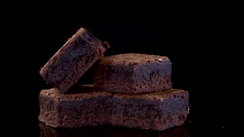 Rotating Stack of Chocolate Brownie Squares on Black Background Stock Footage 315015557