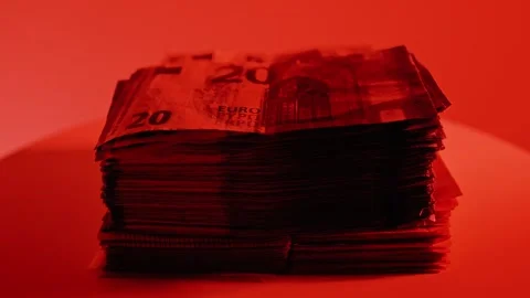 Rotating Stack of Twenty Euro Banknotes Under Dramatic Red Light Scene Stock Footage 337621432