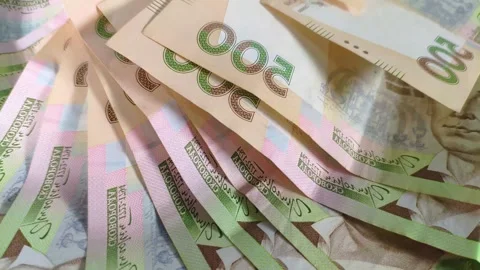 Rotating stack of Ukrainian hryvnia (UAH) banknotes viewed from the top, seamles Stock Footage 272443721