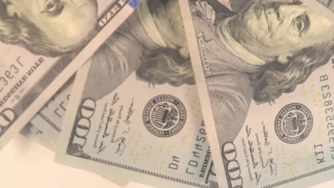 Rotating stack of US dollar banknotes viewed from the top, seamless spinning mot Stock Footage 272442301