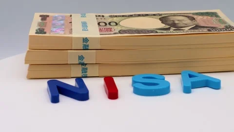 Rotating stacks of bills and the word NISA Stock-Footage 325695672