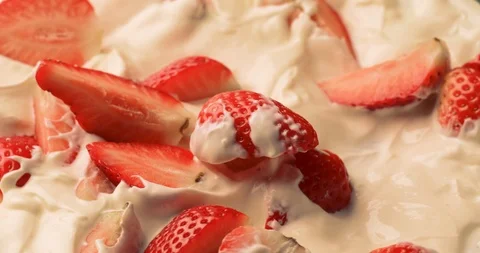 Rotating strawberry slices in yogurt Stock Footage 126059702