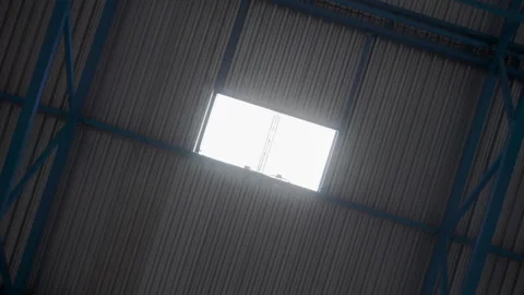Rotating  structural ceiling and light up window in warehouse hangar structure Stock Footage 139685563