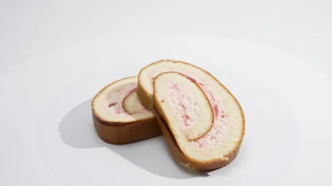 Rotating studio clip of layered Swiss roll slices arranged in a small stack. Stock Footage 322119932