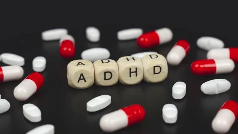 On a rotating surface lie capsules, tablets and cubes with the inscription -ADHD Stock Footage 213200646