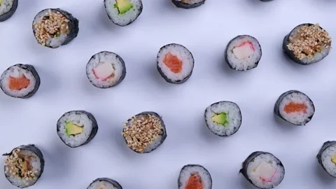 Rotating sushi maki rolls on white background top view Stock Footage 220451812