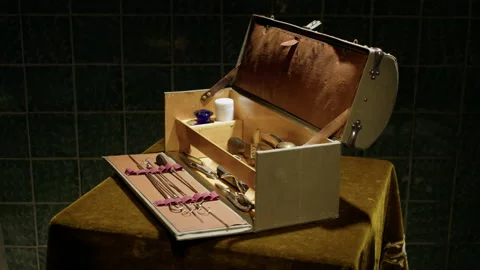 On a rotating table covered with green velour material, a white suitcase spins. Stock Footage 221843367