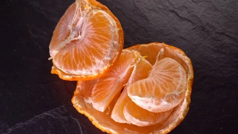 Rotating tangerines close up on a dark background Stock Footage 122645814