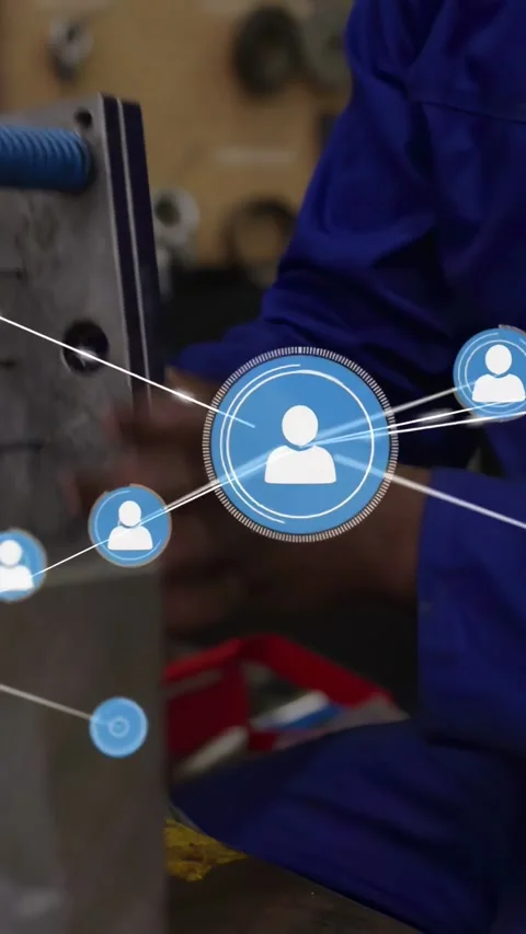 Rotating tech in blue coverall inspecting metal part with spring at bench, with Stock Footage 331168893