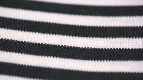 Rotating texture of black and white striped knitted cotton material. closeup. Stock Footage 243190347