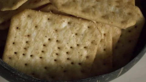 Rotating texture of Movin cracker with salt in a plate close-up, bokeh. Stock Footage 146279670