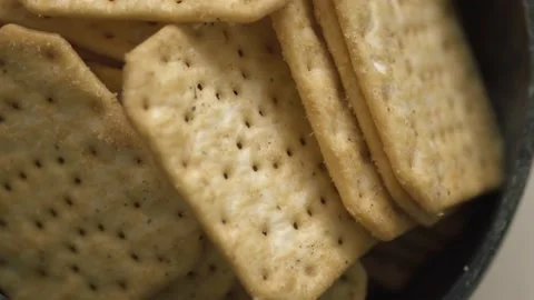 Rotating texture of Movin cracker with salt in a plate close-up, bokeh. Stock Footage 146279731