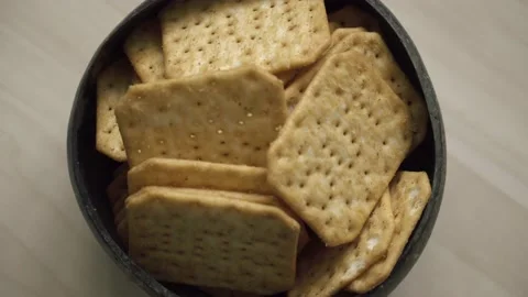 Rotating texture of Movin cracker with salt in a plate close-up, bokeh. Stock Footage 146279754
