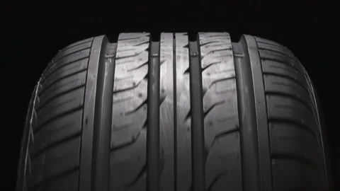 Rotating Tire on a Black Background 4K Stock Footage 338342020